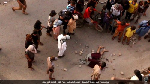 Image released by ISIS showing citizens of Kirkuk stoning the lifeless body of a man executed for being gay.