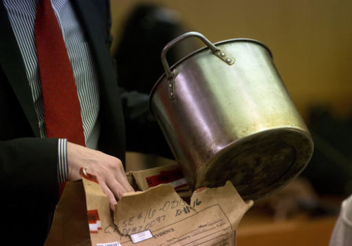 During the trial for Martin Blackwell a lawyer holds a pot they say Blackwell used to pour boiling water on his girlfriend's gay son and his friend as they slept, in Atlanta, Tuesday, Aug. 23, 2016.