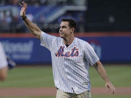 Former Major League Baseball player Billy Bean waves to baseball fans after throwing out the first pitch before the start of a baseball game between the New York Mets and the San Diego Padres, Saturday, Aug. 13, 2016, in New York. Bean threw out the pitch on the first Mets Pride Night.