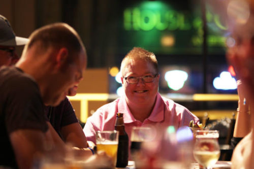 In this Tuesday, Sept. 13, 2016 photo, Angela Caddell smiles during a "Jesus & Beer" event at a Waukesha, Wis., pub, organized by CollectiveMKE church, which doesn't have a traditional building. The group holds these discussions once a month at Milwaukee and Waukesha bars. It's part of an effort by religious groups nationwide looking for ways to recruit new parishioners, connect with people struggling with their faith or give a different, relaxed outlet to talk religion.
