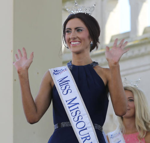 FILE - In this Tuesday, Aug. 30, 2016 file photo, Miss Missouri, Erin O'Flaherty waves as she is introduced during Miss America Pageant arrival ceremonies in Atlantic City. After competing in pageants for generations in the closet or working behind the scenes, gays and lesbians finally get to see one of their own take one of pageantry's biggest stages. O' Flaherty, will compete for the Miss America crown on Sept. 11, as the first openly lesbian contestant.