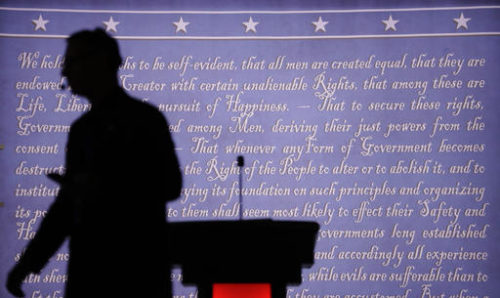 A producer walks past a podium on the stage for the presidential debate between Democratic presidential candidate Hillary Clinton and Republican presidential candidate Donald Trump at Hofstra University in Hempstead, N.Y., Monday, Sept. 26, 2016.