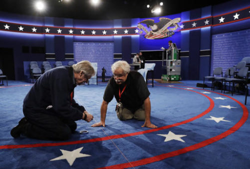 Workers prepare the stage for the second presidential debate between Republican presidential nominee Donald Trump Democratic presidential nominee Hillary Clinton at Washington University in St. Louis, Saturday, Oct. 8, 2016.