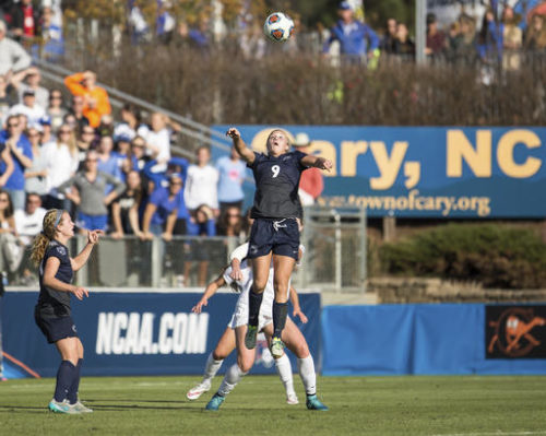 FILE - In this Dec. 6, 2015, file photo, Penn State’s Frannie Crouse (9) jumps for a header as teammate Emily Ogle, left, watches during the NCAA Women's College Cup soccer final against Duke in Cary, N.C. The NCAA relocated its men's basketball regional tournament to Greenville, South Carolina, on Friday, Oct. 7, 2016, after withdrawing the event from Greensboro, North Carolina, because of that state's law restricting the rights of LGBT people. The NCAA also announced the relocation of six other events from North Carolina, including the Division 1 women's soccer championship.