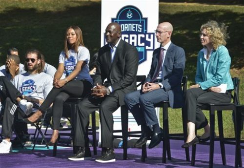 Charlotte Hornets owner Michael Jordan, center, with NBA Commissioner Adam Silver, second from right, and Charlotte Mayor Jennifer Roberts, right, attend the dedication of the basketball courts by the Hornets and NBA at Latta Park in the Dilworth neighborhood of Charlotte, N.C., Tuesday, Oct. 18, 2016. Silver said Tuesday that returning the All-Star Game to Charlotte in 2019 is "a high priority," provided there's a resolution to a North Carolina law that restricts the rights of LGBT people.