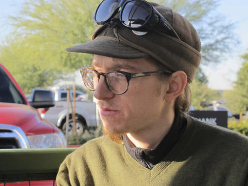 Christopher Farstad, a musician from Minneapolis, speaks with his father, James, at a coffee shop Friday, Dec. 9, 2016, in Gilbert, Ariz. Farstad was among a group of people attending a music event inside a warehouse in Oakland, Calif., on Friday night, Dec 2, 2016, when a fire tore through the building, killing dozens of people. He described the scene as a "hellish situation."