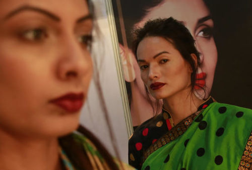 In this Feb. 2, 2017 photo, Anjali Lama, a transgender model from Nepal, stands backstage at the Lakme Fashion week in Mumbai, India. Growing up as the fifth son in a poor farming family in rural Nepal the dream to be a fashion model came late in life. First came a long, painful struggle to accept that he felt deeply female. It was a chance encounter with a group of transgender women that turned Lama's life around by putting her in touch with the Blue Diamond Society, an advocacy group for Nepal's LGBT community. In 2005 she came out to her friends and family as a transgender woman.