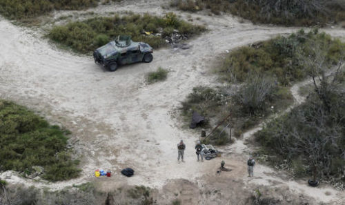 FILE - In this Feb. 24, 2015, file photo, members of the National Guard patrol along the Rio Grande at the Texas-Mexico border in Rio Grande City, Texas. The Trump administration is considering a proposal to mobilize as many as 100,000 National Guard troops to round up unauthorized immigrants, including millions living nowhere near the Mexico border, according to a draft memo obtained by The Associated Press.