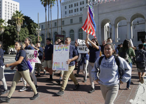FILE - In this Monday, Nov. 14, 2016 file photo, East Los Angeles high school students protest against the election of President-elect Donald Trump outside Los Angeles City Hall. Mixed signals from the White House on gay rights and conscience protections have put two constituencies on edge: LGBT advocates already wary of President Donald Trump and religious conservatives determined to hold him to his campaign promises. (AP Photo/Nick Ut)