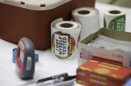 FILE - This Tuesday, April 21, 2015 file photo shows stickers given to clients after they get tested for HIV at the Austin Community Outreach Center in Austin, Ind. The nation is seeing a steady and substantial decline in the number of new HIV infections occurring each year, according to new federal estimates released on Tuesday, Feb. 14, 2017.