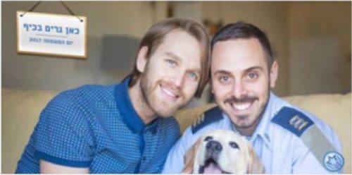 Capt. Adir Gabbai, right, and his husband, Dean, posing with their dog in a photo for Family Day. gay couple Israeli Air Force