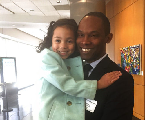 In this photo provided by Vanessa Ford, taken March 8, 2017, Ellie Ford, 5, with her father JR Ford, are seen before their meeting with Education Secretary Betsy DeVos in Washington. Families of transgender students came away from a meeting with Education Secretary Betsy DeVos saying that she was receptive to their concerns but must now follow up with action.
