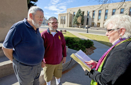 FILE - In this Oct. 21, 2014, file photo, Marvin Witt, left, and Mike Romero are married by nondenominational chaplain Pamela RW Kandt in downtown Casper, Wyo. The Wyoming Supreme Court has decided to censure but not remove a Pinedale judge who says her religious beliefs prevent her from presiding over same-sex marriages. The court split 3-2 on its decision Tuesday, March 7, 2017 in the case of Judge Ruth Neely. The majority says Neely violated judicial conduct code, but her misconduct doesn't warrant removing her from the bench.