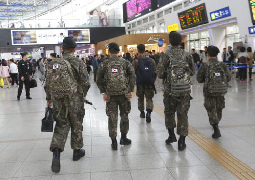 In this Thursday, April 20, 2017 photo, South Korean army soldiers walk to take their trains at Seoul Railway Station in Seoul, South Korea. A watchdog group says South Korea's army is hunting down and prosecuting gay servicemen after a video of two male soldiers having sex was posted on the internet earlier this year, stoking fear in an already persecuted minority group.