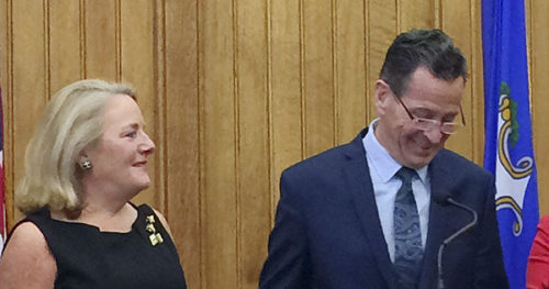 Connecticut Gov. Dannel P. Malloy holds the hand of his wife Cathy after announcing Thursday, April 13, 2017, at the Capitol in Hartford, Conn., that he will not seek a third term in 2018.