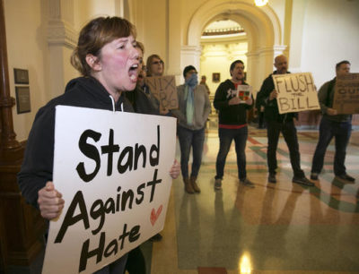 Protestors try to drown out a press conference with Texas Lt. Gov. Dan Patrick and Senator Lois Kolkhorst as they introduce Senate Bill 6 known as the Texas Privacy Act, which provides solutions to the federal mandate of transgender bathrooms, showers and dressing rooms in all Texas schools. Katie Graham shouts and makes loud noise to hinder the announcement of the filing of the bill at the state Capitol Thursday, Jan. 5, 2017.