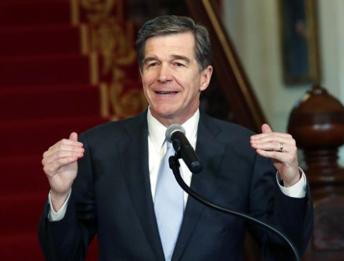 North Carolina Gov. Roy Cooper holds a press conference at the Executive Mansion in Raleigh, N.C., Thursday, March 30, 2017, to announce that he signed a HB142, a compromise replacement bill for HB2, that the N.C. General Assembly passed earlier in the day.
