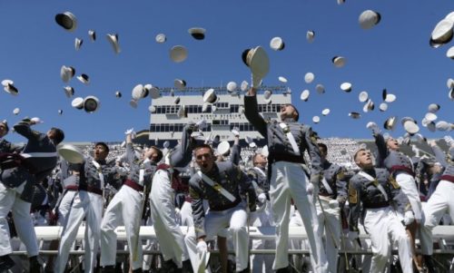 Graduating cadets toss their hats into the air at the end of a graduation and commissioning ceremony at the U.S. Military Academy on May 23, 2015, in West Point, N.Y.