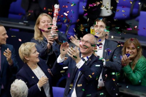 Green Party's gay rights activist Volker Beck, front right, and fellow faction members celebrate with a confetti popper after German Federal Parliament, Bundestag, voted to legalize same-sex marriage in Berlin, Germany, Friday, June 30, 2017. germany marriage equality