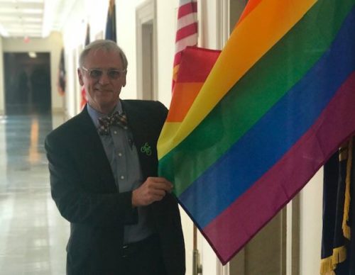 Congressman Earl Blumenauer with the pride flag outside of his office. Earl Blumenauer pride flag