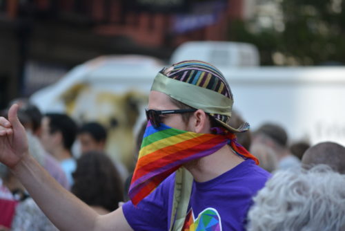 New York, New York. - August 13, 2017: Protester at a rally in Union Square denouncing neo-nazi violence in Charlottesville, Virginia and President Trump in 2017 in New York City. rainbow-mask-protestor
