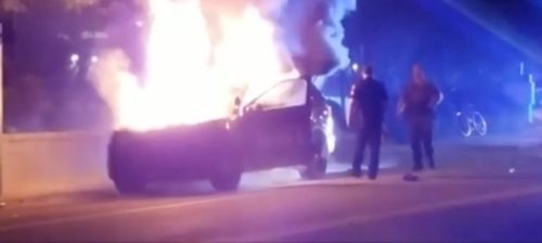 A police car burns after students rioted at Georgia Tech following the execution of an unarmed student.