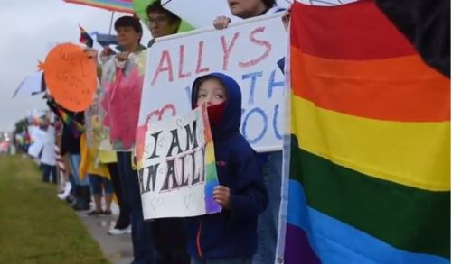 LGBTQ community members and allies rally in support of bullied stories. lgbt ally rally