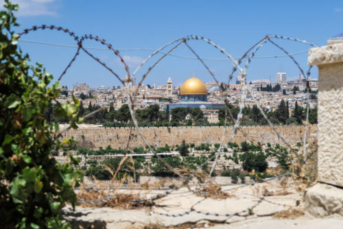Old Jerusalem seen through barbed wire.