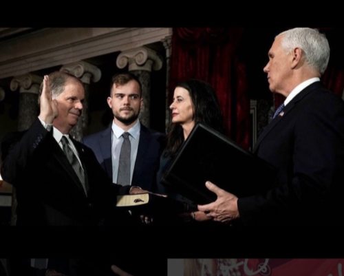Carson Jones watches as Vice President Mike Pence administers the oath of office to his father, Alabama's newest senator, Doug Jones.
