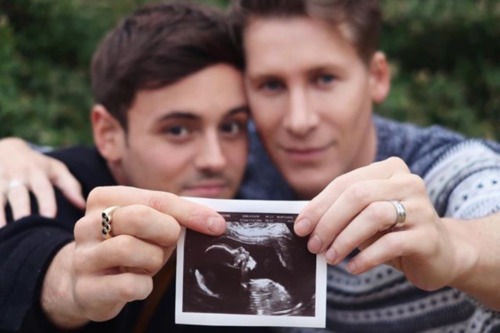 Tom Daley and Dustin Lance Black pose together with a sonogram of their baby Tom Daley Dustin Lance Black baby