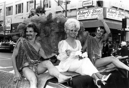 A drag queen and her subjects ride in a convertible in the Los Angeles Christopher Street West pride parade, June 27, 1971.