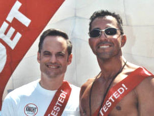 Two men promote HIV testing at the Los Angeles Christopher Street West Pride Parade, June 13, 1999.
