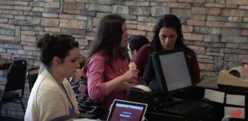 A customer looks on as an actor pretending to be a baker refuses to serve a lesbian couple. The couple were also actors. A customer looks on as an actor pretending to be a baker refuses to serve a lesbian couple. The couple were also actors.