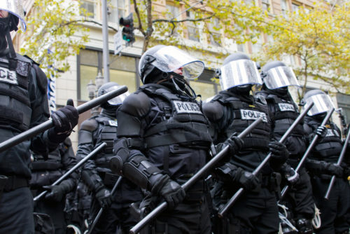Police in riot gear hold the line in Downtown Portland, Oregon during an Occupy Portland protest on the first anniversary of Occupy Wall Street November 17, 2011 Police in riot gear hold the line in Downtown Portland, Oregon during an Occupy Portland protest on the first anniversary of Occupy Wall Street November 17, 2011