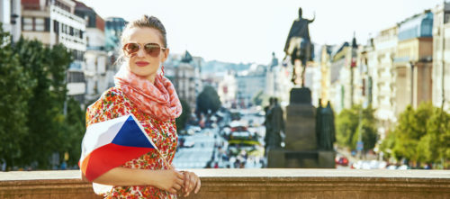 A woman holds a Czech flag in Prague