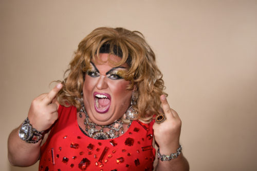 A drag queen flips off the camera