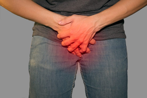 Man holding his genitals