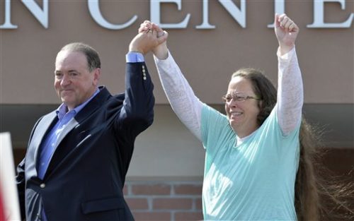 FILE - In this Sept. 8, 2015, file photo, Rowan County Clerk Kim Davis, with Republican presidential candidate Mike Huckabee at her side, greets the crowd after being released from the Carter County Detention Center, in Grayson, Ky. Davis, hauled to jail for defying a series of federal court orders and refusing to issue marriage licenses to same-sex couples, filed a 40-page court document Thursday, Sept. 24, blaming Kentucky governor Steve Beshear for all her legal woes. FILE - In this Sept. 8, 2015, file photo, Rowan County Clerk Kim Davis, with Republican presidential candidate Mike Huckabee at her side, greets the crowd after being released from the Carter County Detention Center, in Grayson, Ky. Davis, hauled to jail for defying a series of federal court orders and refusing to issue marriage licenses to same-sex couples, filed a 40-page court document Thursday, Sept. 24, blaming Kentucky governor Steve Beshear for all her legal woes.