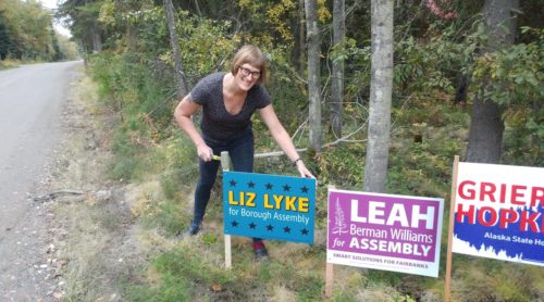 Liz Lyke poses with a yard sign. Liz Lyke poses with a yard sign.