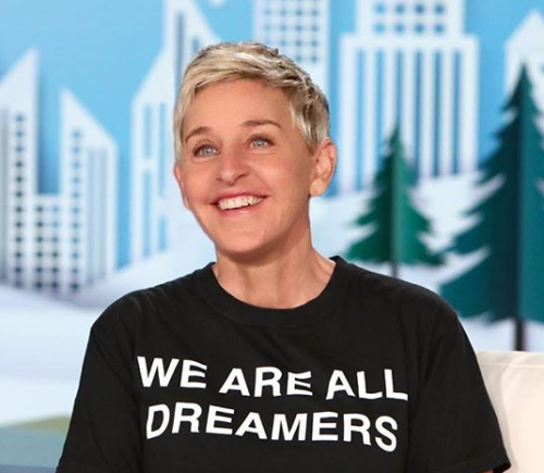Ellen wearing a black T-shirt that says "We are all dreamers."