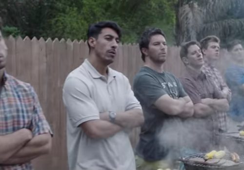 Lots of men in front of barbecues.