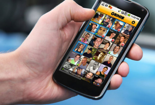 A phone with Grindr on