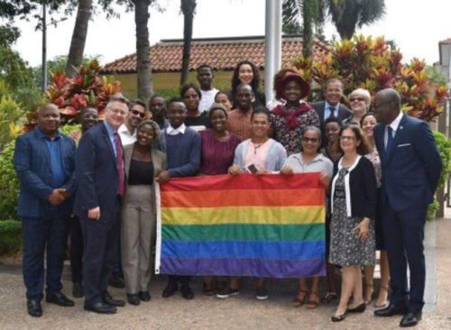 Members of Iris Angola standing around a flag