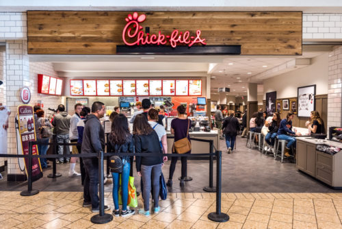 Fairfax, USA - February 18, 2017: Chick-fil-A store with people in line waiting to buy food Fairfax, USA - February 18, 2017: Chick-fil-A store with people in line waiting to buy food