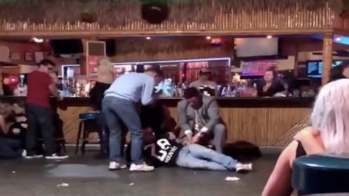 Patrons assist a wounded man at Toucan's Tiki Bar in Palm Springs, CA Patrons assist a wounded man at Toucan's Tiki Bar in Palm Springs, CA