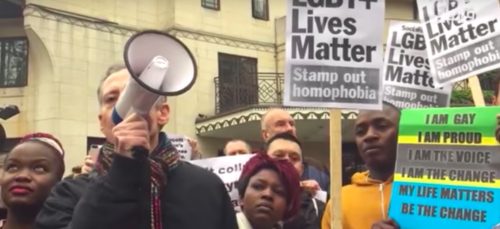 LGBTQ activist Peter Tatchell yells on a bullhorn while other protestors hold signs at a demonstration against Brunei's new anti-queer stoning law Brunei protests