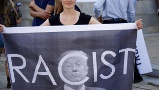 racist-banner-trump-323x183.jpg