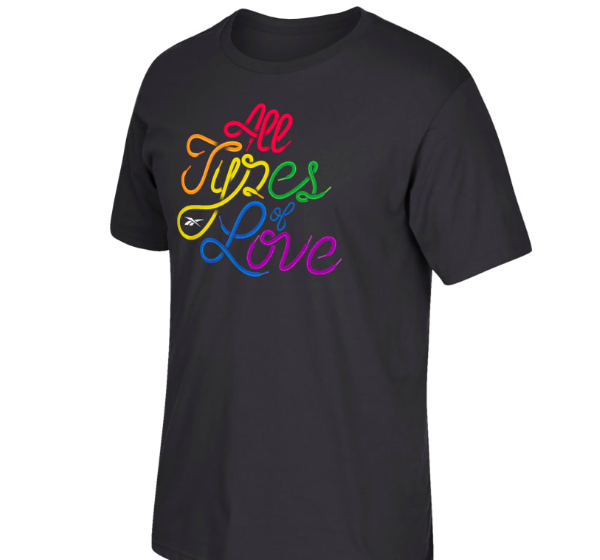 A photo of a Reebok shirt that says "All Types of Love" in cursive, rainbow lettering.