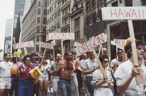 Men and women carry signs during the Gay Pride parade in New York City, June 1984.