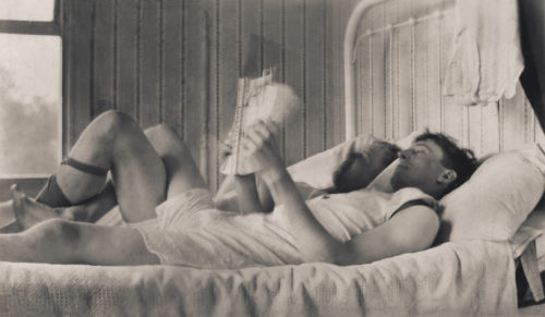 A rare photo of two men in bed together as a couple.